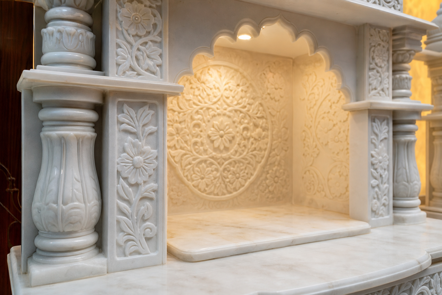 Hand-carved white marble mandir temple with intricate floral pillar detailing in Dubai